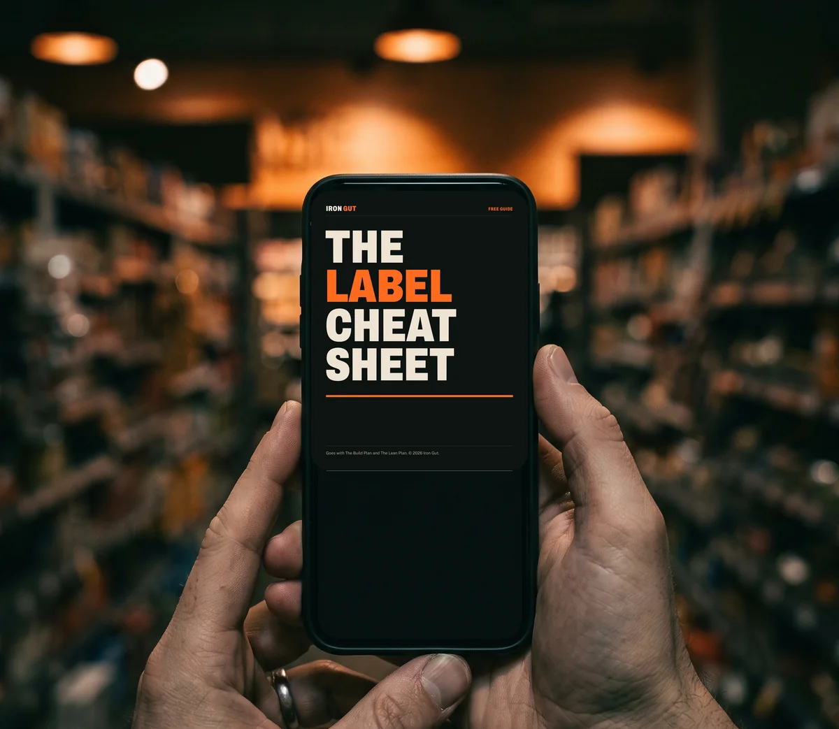 A phone held up in a supermarket aisle